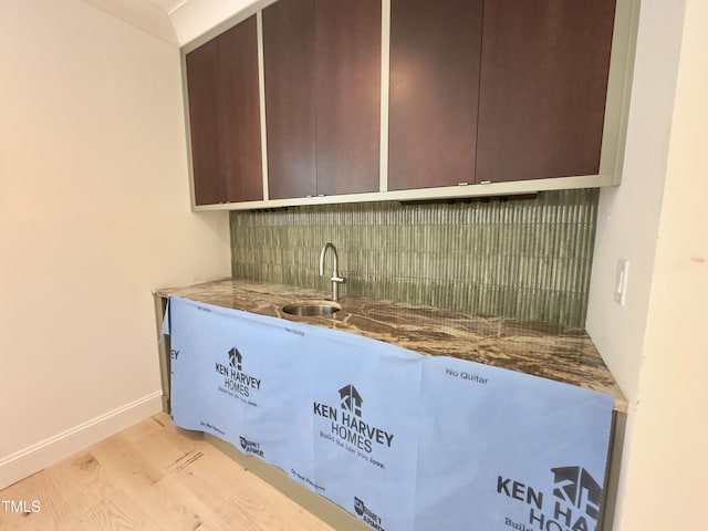 7208 Tanbark Way, Raleigh, NC 27615 - indoor wet bar featuring backsplash and light wood finished floors