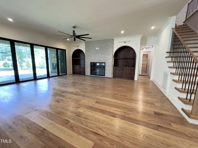 7208 Tanbark Way, Raleigh, NC 27615 - unfurnished living room with a ceiling fan, stairs, wood finished floors, crown molding, and recessed lighting