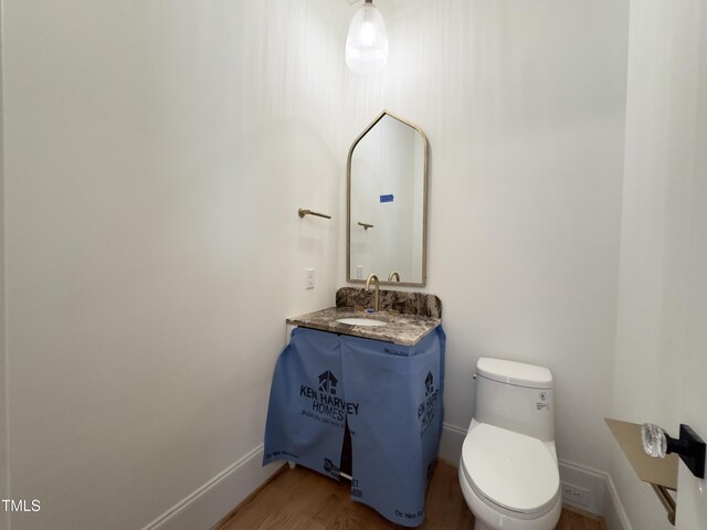 7208 Tanbark Way, Raleigh, NC 27615 - bathroom with wood finished floors and vanity