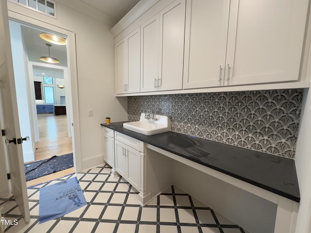 7208 Tanbark Way, Raleigh, NC 27615 - laundry area featuring a sink and light floors