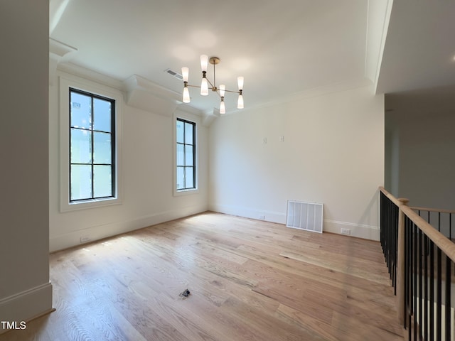 7208 Tanbark Way, Raleigh, NC 27615 - spare room with crown molding, a chandelier, and wood finished floors