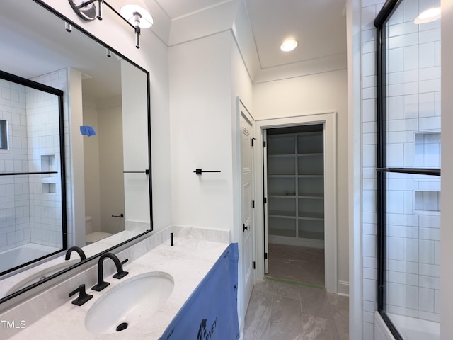 7208 Tanbark Way, Raleigh, NC 27615 - full bathroom featuring double vanity, shower / bath combination with glass door, marble finish floors, a walk in closet, and recessed lighting
