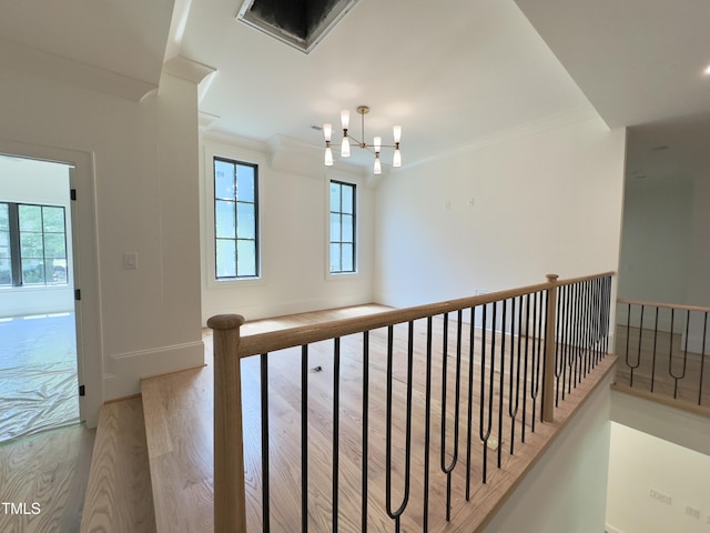 7208 Tanbark Way, Raleigh, NC 27615 - stairway with plenty of natural light, wood finished floors, ornamental molding, and a chandelier