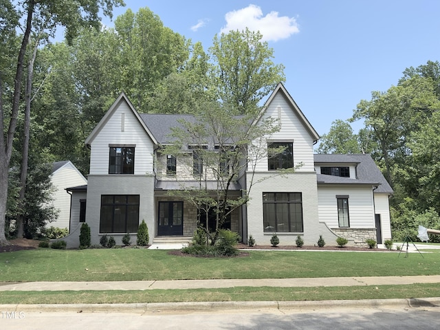 7208 Tanbark Way, Raleigh, NC 27615 - modern farmhouse featuring a front lawn and a shingled roof
