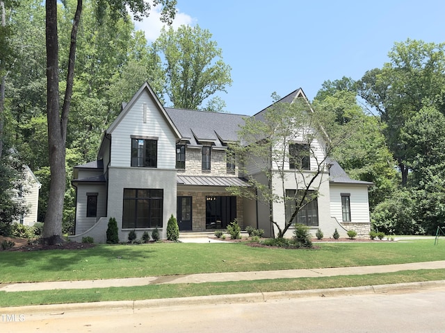7208 Tanbark Way, Raleigh, NC 27615 - modern farmhouse with covered porch, a front yard, and stone siding