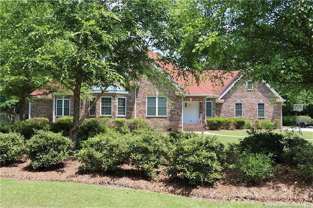 view of front of property with a front yard and brick siding