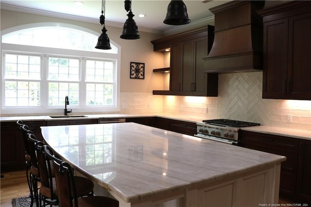 kitchen with light wood-type flooring, custom range hood, a kitchen island, and backsplash