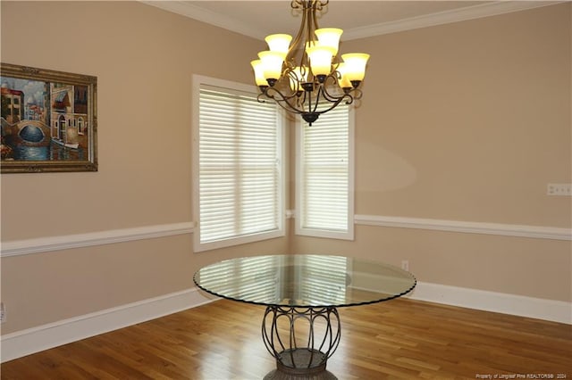 unfurnished dining area with plenty of natural light, wood-type flooring, and a chandelier