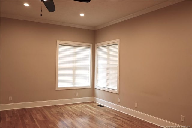 empty room with wood-type flooring, ornamental molding, and ceiling fan