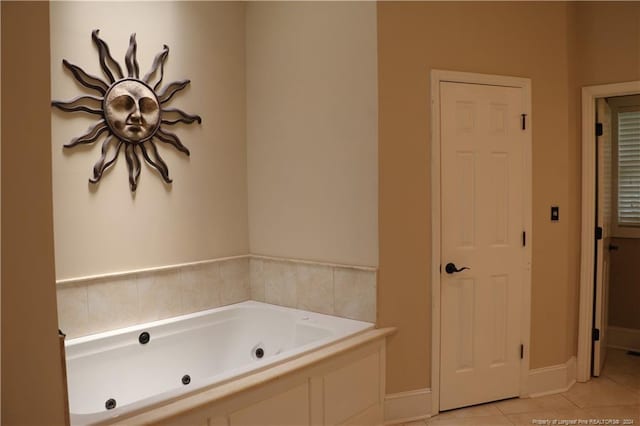 bathroom with a bathtub and tile patterned flooring