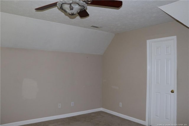 bonus room featuring ceiling fan, vaulted ceiling, a textured ceiling, and carpet