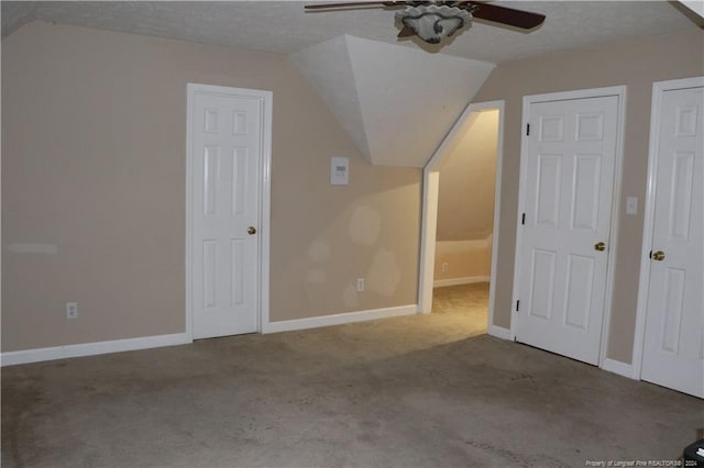 additional living space with ceiling fan, vaulted ceiling, a textured ceiling, and carpet floors