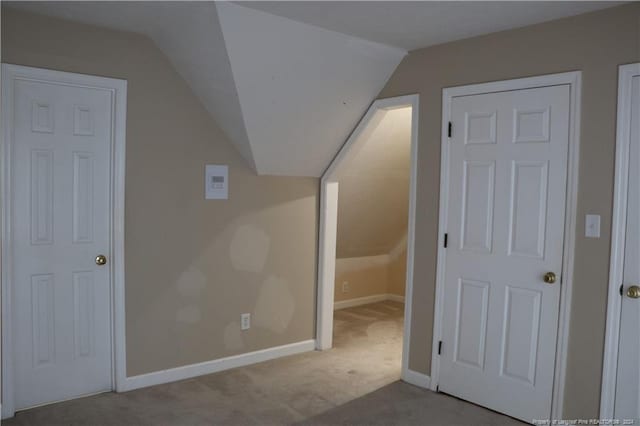 additional living space featuring carpet flooring and lofted ceiling