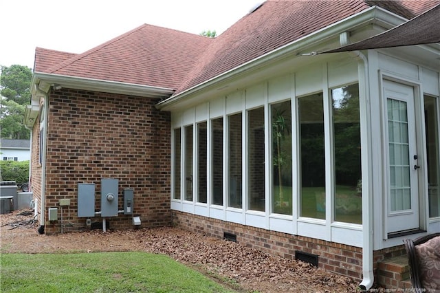 view of side of home with a sunroom