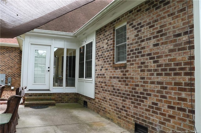 view of exterior entry featuring a patio