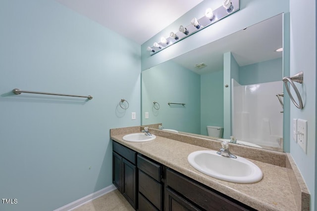 bathroom with vanity, walk in shower, and toilet