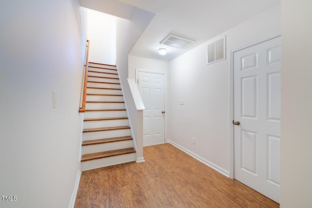 stairs with hardwood / wood-style flooring