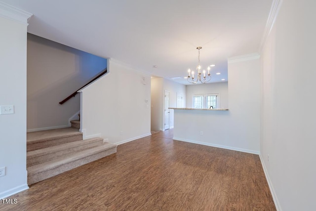 unfurnished living room featuring wood-type flooring, a notable chandelier, and crown molding