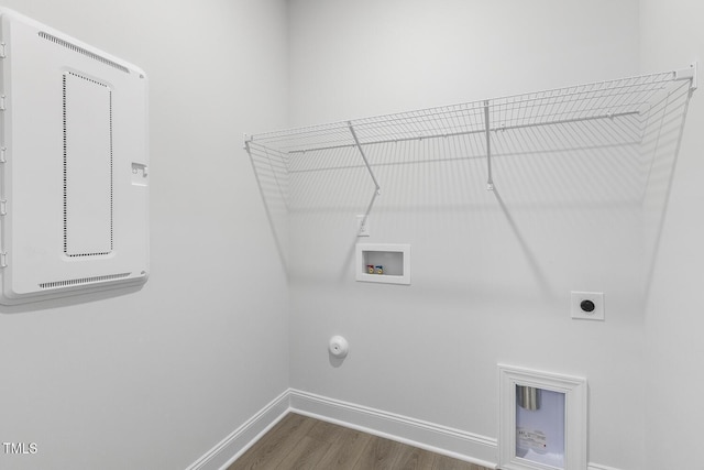 laundry room featuring wood-type flooring, hookup for a washing machine, hookup for a gas dryer, and hookup for an electric dryer