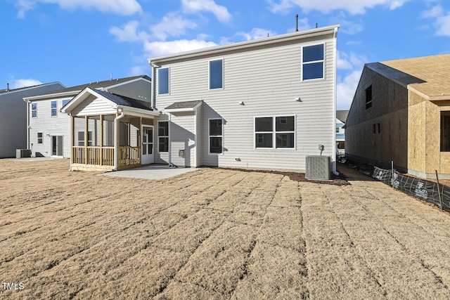 rear view of property featuring a patio and central AC