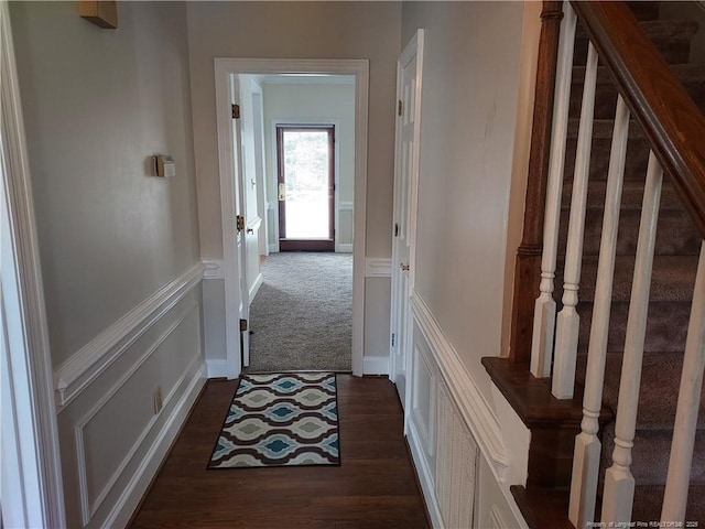 corridor featuring dark colored carpet