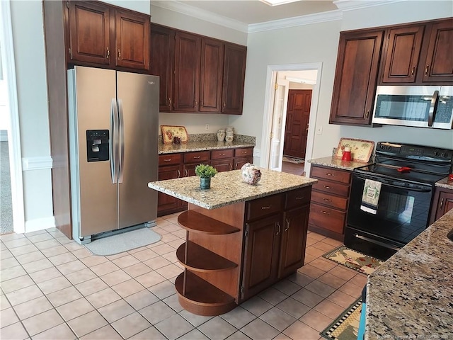 kitchen with light stone counters, stainless steel appliances, crown molding, and dark brown cabinetry