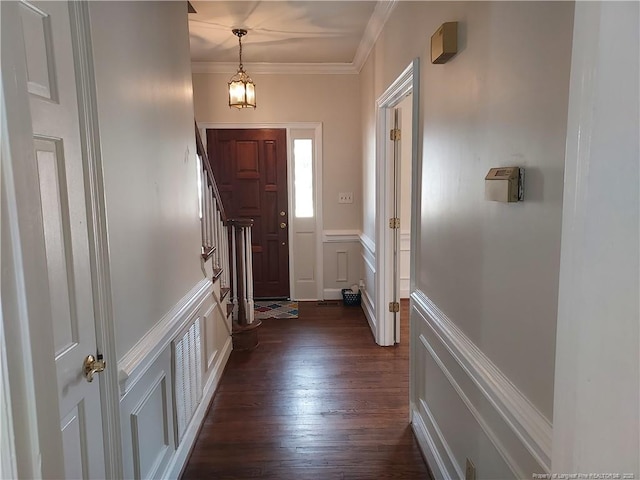 doorway featuring dark wood-type flooring and ornamental molding