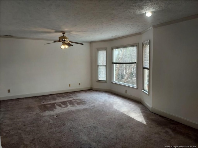 empty room featuring a textured ceiling, ceiling fan, crown molding, and carpet floors