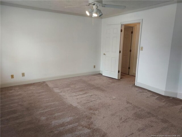 unfurnished room featuring ceiling fan, ornamental molding, and carpet