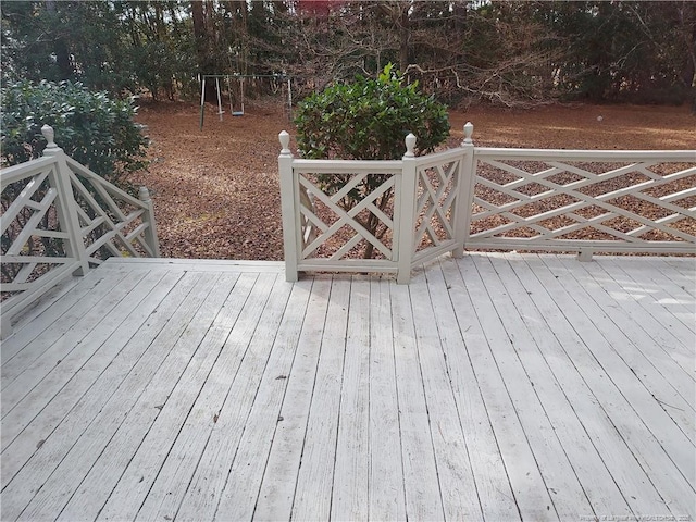 wooden deck featuring a playground