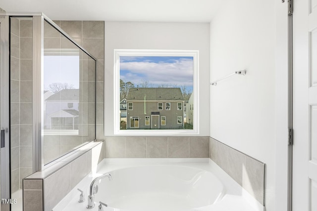 bathroom featuring separate shower and tub