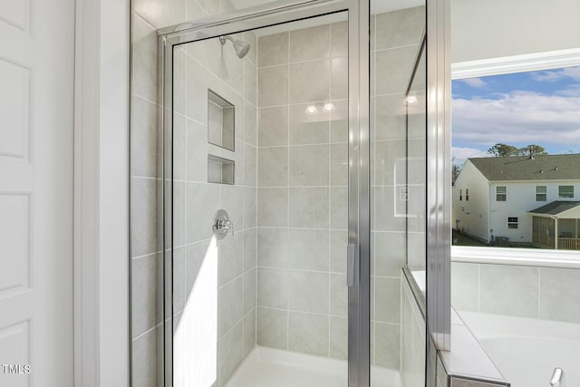 bathroom with separate shower and tub