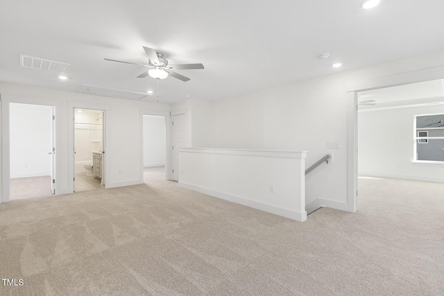 unfurnished room featuring ceiling fan and light carpet