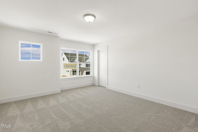 unfurnished room featuring light colored carpet