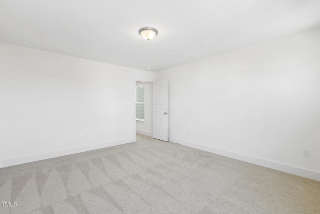 unfurnished room with light colored carpet