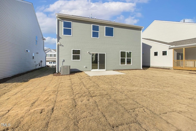 rear view of house featuring a patio and cooling unit