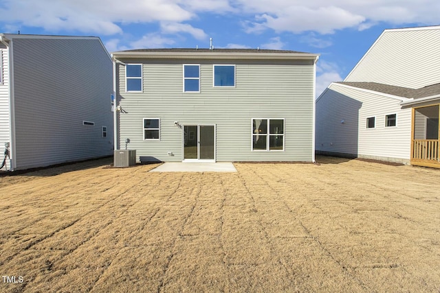 back of property with central AC unit and a patio