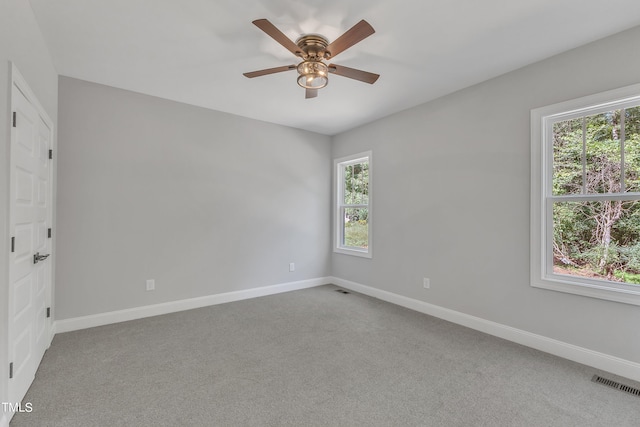 carpeted spare room with ceiling fan