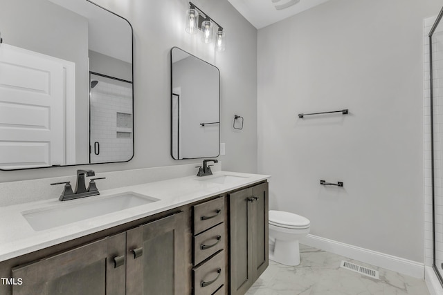 bathroom with vanity, toilet, and a shower with shower door