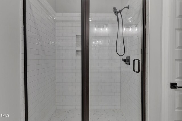 bathroom featuring a shower with door