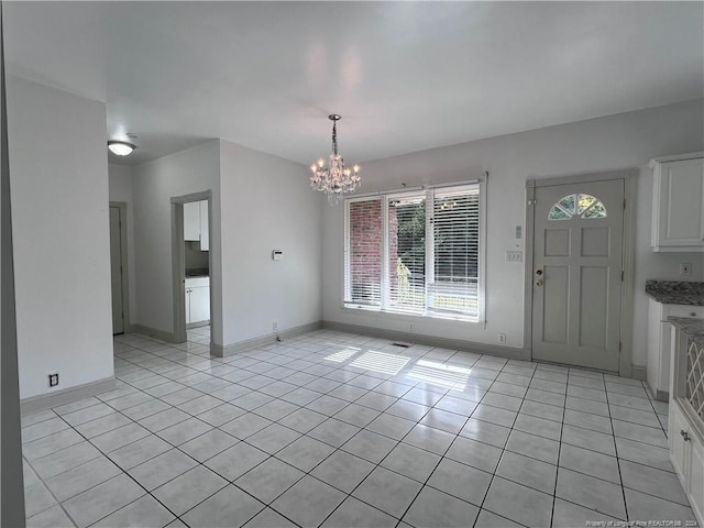 tiled entrance foyer featuring a chandelier