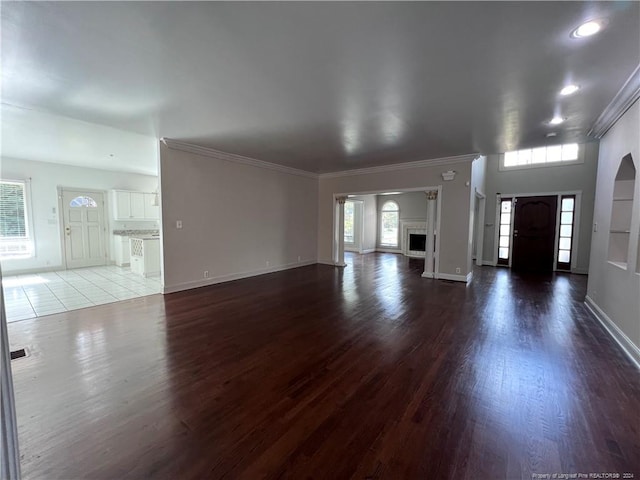 unfurnished living room featuring ornamental molding and hardwood / wood-style floors