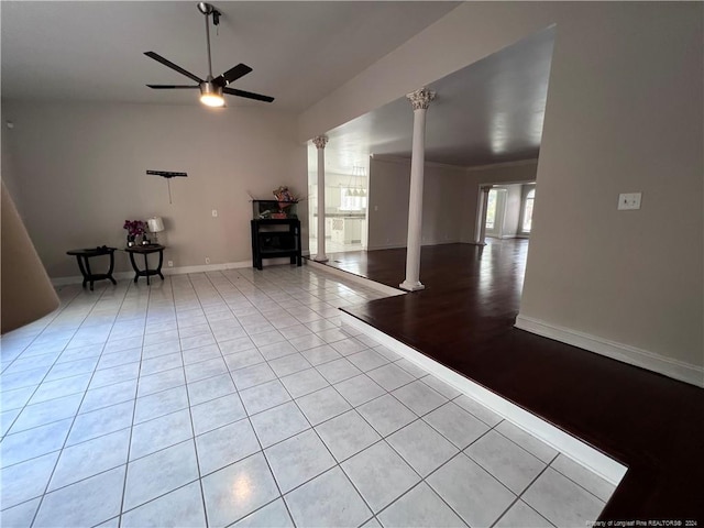 spare room with light tile patterned floors, ornate columns, and ceiling fan