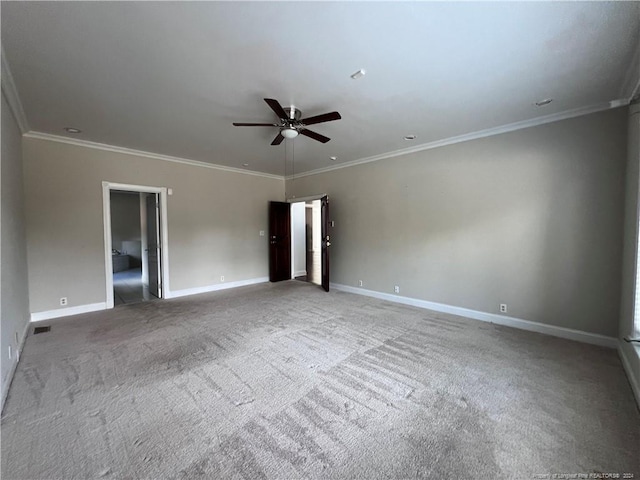 carpeted empty room featuring ornamental molding and ceiling fan