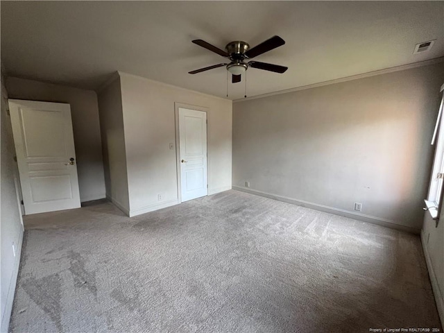 unfurnished bedroom featuring crown molding, light colored carpet, and ceiling fan