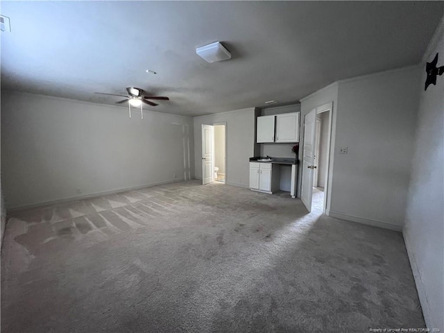 unfurnished living room featuring carpet floors and ceiling fan