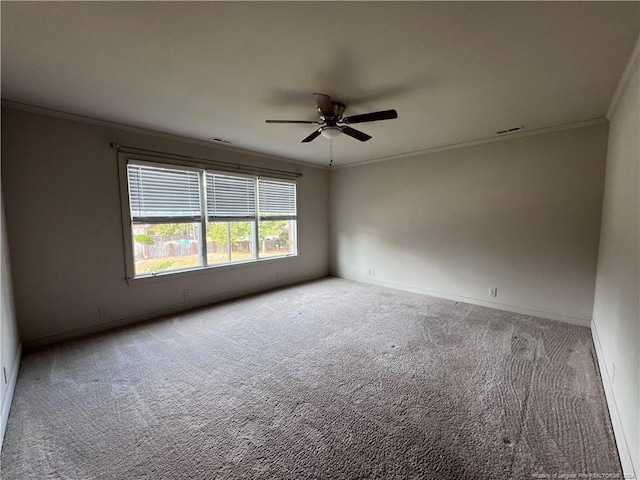 empty room with ornamental molding, carpet floors, and ceiling fan