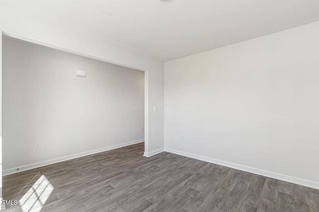 spare room featuring dark hardwood / wood-style flooring