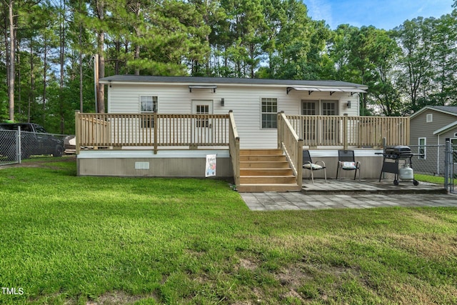 back of house featuring a yard and a wooden deck