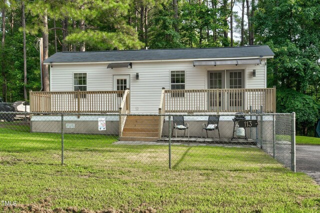 exterior space with a wooden deck and a front yard